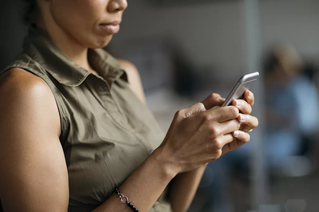 Entrepreneur working on her phone at the office